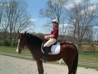 Rider tilted back, pushing saddle forward, legs in front