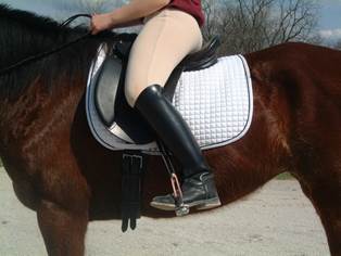 Rider bent to right, outside leg back